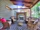 Inviting back porch with a fireplace and several wicker chairs at 2859 Seagrave Way, Marietta, GA 30066