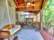 Inviting covered back porch with a fireplace, ceiling fans, and a porch swing at 2859 Seagrave Way, Marietta, GA 30066