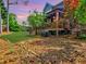 Landscaped backyard features a covered deck, vibrant plants, and a well-manicured lawn at 2859 Seagrave Way, Marietta, GA 30066