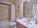 Bathroom with neutral tile, shower-tub combination, and a cherry vanity at 2859 Seagrave Way, Marietta, GA 30066