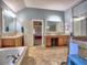 A spacious bathroom has a garden tub and double vanity with a doorway to the bedroom at 2859 Seagrave Way, Marietta, GA 30066