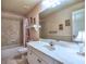 Well-lit bathroom featuring a tub-shower combination and a white vanity with marble countertop at 2859 Seagrave Way, Marietta, GA 30066