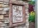 Stone-framed Heritage Manor community sign with elegant lettering and colorful landscaping at 2859 Seagrave Way, Marietta, GA 30066