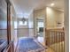 Upstairs hallway with hardwood floors and a decorative chandelier above the foyer below at 2859 Seagrave Way, Marietta, GA 30066