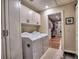 Laundry room with washer, dryer, white cabinetry and door leading to the closet at 2859 Seagrave Way, Marietta, GA 30066
