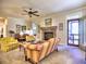 Bright living room features a cozy fireplace, ceiling fan, and access to an outdoor deck for seamless indoor-outdoor living at 2859 Seagrave Way, Marietta, GA 30066