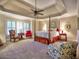 Spacious main bedroom boasts a tray ceiling, plantation shutters, and sitting area at 2859 Seagrave Way, Marietta, GA 30066