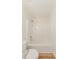 Bathroom features a new shower-tub combo with sleek, modern fixtures and white tile at 9482 Deer Crossing Ln, Jonesboro, GA 30236