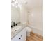 Bathroom features granite countertops, and shower-tub combo with modern lighting at 9482 Deer Crossing Ln, Jonesboro, GA 30236