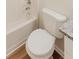 Bright bathroom featuring a shower-tub combo, toilet and granite vanity at 9482 Deer Crossing Ln, Jonesboro, GA 30236