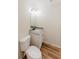 Well lit half bathroom featuring granite countertop and wood-look flooring at 9482 Deer Crossing Ln, Jonesboro, GA 30236