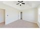 Bright bedroom with tray ceiling, ceiling fan, neutral carpet and trim at 9482 Deer Crossing Ln, Jonesboro, GA 30236