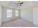 Bright bedroom with large windows, neutral carpet and tray ceiling at 9482 Deer Crossing Ln, Jonesboro, GA 30236