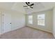 Bright bedroom with large windows, neutral carpet and tray ceiling at 9482 Deer Crossing Ln, Jonesboro, GA 30236