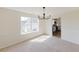 Bright dining area features a modern light fixture, fresh paint, and large window, creating an inviting space at 9482 Deer Crossing Ln, Jonesboro, GA 30236