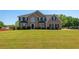 Beautiful two-story brick home with large front yard and classic black shutters at 9482 Deer Crossing Ln, Jonesboro, GA 30236