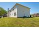 Exterior view of the house showing white siding and a well-manicured lawn at 9482 Deer Crossing Ln, Jonesboro, GA 30236