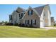A two-story brick home with an attached garage sits on a lush green lawn at 9482 Deer Crossing Ln, Jonesboro, GA 30236