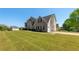 View of the house with a large front yard and two car garage on a sunny day at 9482 Deer Crossing Ln, Jonesboro, GA 30236