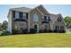 A charming two-story home with a well-kept lawn and manicured bushes at 9482 Deer Crossing Ln, Jonesboro, GA 30236