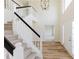 Spacious two-story foyer featuring hardwood floors and staircase at 9482 Deer Crossing Ln, Jonesboro, GA 30236