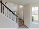 Two-story foyer with hardwood floors, a modern chandelier, and staircase at 9482 Deer Crossing Ln, Jonesboro, GA 30236