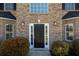 Welcoming entryway with a black front door, sidelights, and traditional brick surround at 9482 Deer Crossing Ln, Jonesboro, GA 30236