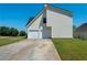 Two car garage with white doors and concrete driveway at 9482 Deer Crossing Ln, Jonesboro, GA 30236