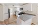 Modern kitchen features white cabinets, stainless steel appliances, and granite countertops with an open concept at 9482 Deer Crossing Ln, Jonesboro, GA 30236
