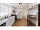 Open kitchen showcasing stainless steel appliances, granite counters and views to the living spaces at 9482 Deer Crossing Ln, Jonesboro, GA 30236