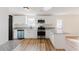 Modern kitchen with white cabinets, stainless steel appliances, and granite countertops, offers a stylish workspace at 9482 Deer Crossing Ln, Jonesboro, GA 30236