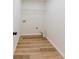 A spacious laundry room with modern flooring, and hookups for washer and dryer at 9482 Deer Crossing Ln, Jonesboro, GA 30236