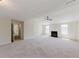 Bright and airy living room featuring a fireplace and ceiling fan at 9482 Deer Crossing Ln, Jonesboro, GA 30236