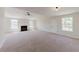 Large living room with ceiling fan, fireplace, and plenty of natural light at 9482 Deer Crossing Ln, Jonesboro, GA 30236