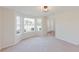 Bright living room featuring carpet floors and bay windows at 9482 Deer Crossing Ln, Jonesboro, GA 30236