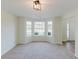 Inviting living room with bay windows offering natural light and views of the neighborhood at 9482 Deer Crossing Ln, Jonesboro, GA 30236