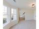 Living room with carpet floors and view of entrance and staircase at 9482 Deer Crossing Ln, Jonesboro, GA 30236