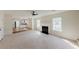 Expansive living room featuring fireplace, ceiling fan, staircase, and doors at 9482 Deer Crossing Ln, Jonesboro, GA 30236