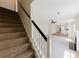 Bright living room with fireplace, staircase, and open layout to kitchen at 9482 Deer Crossing Ln, Jonesboro, GA 30236