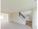 Bright living room features neutral carpet, staircase, and ample natural light, creating a welcoming space at 9482 Deer Crossing Ln, Jonesboro, GA 30236