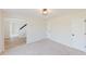 Bright, open living area with hardwood flooring and an adjacent staircase, creating an inviting atmosphere at 9482 Deer Crossing Ln, Jonesboro, GA 30236