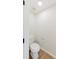 A convenient powder room featuring modern flooring, white fixtures, and a functional layout at 9482 Deer Crossing Ln, Jonesboro, GA 30236