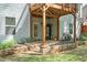 Backyard patio leads to grass lawn with retaining wall and partial view of deck above at 973 Duncan Ter, Canton, GA 30115