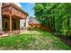 View of the backyard showcasing the deck above, landscaping, and a fenced perimeter at 973 Duncan Ter, Canton, GA 30115