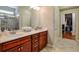 Modern bathroom with double vanity, marble countertops, and glass enclosed shower with tile surround at 973 Duncan Ter, Canton, GA 30115