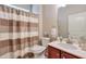 Cozy bathroom featuring a vanity with a single sink and a shower with a striped curtain at 973 Duncan Ter, Canton, GA 30115