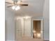 Neutral toned bedroom with ceiling fan and multiple closets and doorway access at 973 Duncan Ter, Canton, GA 30115