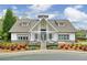 Stunning clubhouse showcasing a white facade with stone accents, complemented by colorful landscaping at 973 Duncan Ter, Canton, GA 30115