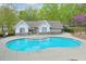 Community pool with surrounding deck, and pool house creating an inviting recreational space at 973 Duncan Ter, Canton, GA 30115