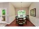 Elegant dining room with wainscoting, hardwood floors, and a modern chandelier, perfect for gatherings at 973 Duncan Ter, Canton, GA 30115